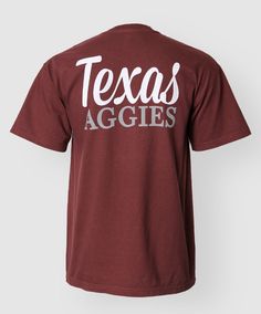 This 100% cotton Maroon Comfort Colors shirt has white and grey text on the back that reads "Texas Aggies". The front has a pocket with the same text on it. Comfort Colors Shirt, Pride Tshirts, Southern Belle, Pocket Top