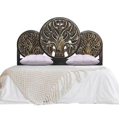 an ornate headboard with two swans on it