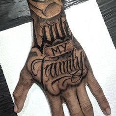 a man's hand with the words my family on it and his name tattooed