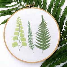 the embroidery pattern shows three different types of plants and leaves, each with green leaves