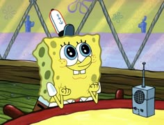 an animated spongebob character sitting in front of a microphone