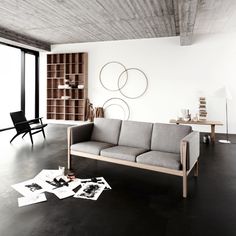 a modern living room with white walls and black flooring