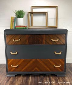 an old dresser has been painted black and gold