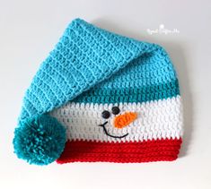 a crocheted hat with a snowman face on it