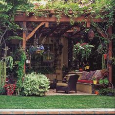 an outdoor living area with lots of plants