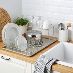 a kitchen counter with dishes and utensils on it