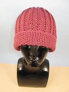 a pink knitted hat sitting on top of a mannequin head