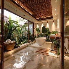 a bathroom with a large tub and plants in it