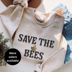 Save Our Bees! Let this sweatshirt be your motivation to help our bees! This fun and cozy sweatshirt would make a great gift for the bee lover in your life or even for yourself!  Please let me know if you have any questions or custom order requests!! All designs can be put on shirts, sweatshirts, tote bags & desk mats, just send me a message! ⭐ABOUT Gildan 18000 brand  Sweatshirt sizes are Unisex, please refer to sizing chart in listing photos 50% cotton, 50% polyester Medium fabric weight DTG Printed ⭐CARE Machine wash: warm (max 40C or 105F)-  Do not iron directly on print ⭐HOW TO ORDER  1-) Please, check and review all photos 2-) Select the color and size of the shirt from the drop-down options. (Actual colors may vary slightly from what appears online due to monitor differences.) 3-) C Bee Sweater, Sweatshirt Cute, Save The Bees, Desk Mats, Branded Sweatshirts, Queen Bee, Cozy Sweatshirts, Queen Bees, Oversized Sweatshirt