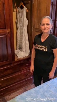 a woman standing in front of a wooden wardrobe