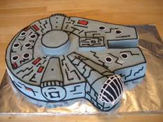 a cake that looks like a star wars vehicle on top of tin foil with the number 6 on it