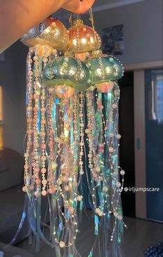 a chandelier hanging from the ceiling in a living room with lights on it