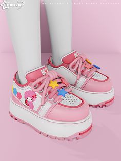 a pair of pink and white shoes with cartoon characters on the upper part of them