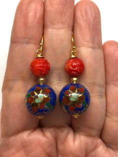 Vintage Chinese Floral Cloisonné Bead from the 60's and Carved Red Sea Bamboo Bead Earrings. Cloisonné is the technique of creating designs on metal vessels with coloured enamel placed within enclosures made of copper or bronze wires. The beads have a beautiful floral pattern with blue, red, green, brown, white and pink enamel. Paired with carved red sea bamboo beads, these are very beautiful and colourful earrings! - Made with Cloisonné Beads from the 60's, Red Sea Bamboo Beads and Gold-plated Handmade Red Enamel Jewelry, Traditional Large Beads Earrings, Vintage Red Beaded Earrings As Gift, Vintage Red Beaded Earrings For Gift, Red Beaded Earrings With Colorful Beads For Festivals, Nickel-free Red Round Earrings, Red Enamel Round Earrings, Red Round Enamel Earrings, Nickel Free Red Earrings