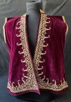 Antique Ottoman embroidered velvet vest, Antique Anatolian handcrafted vest, decorated with metal threads with classical Anatolian patterns on a red velvet background.  There are embroideries on the front and back.    Its usable size is suitable for use by children and teenagers.  It has an old yellow liner inside. *Antique *Velvet and metallic *Good condition Dimensions: 22x26 inches, 58x66 cm  Arm length: 17 inches, 44 cm Red Velvet Background, Vest Embroidery, Textile Embroidery, Velvet Background, Antique Ottoman, Velvet Vest, Embroidered Velvet, Hand Work Embroidery, Antique Textiles