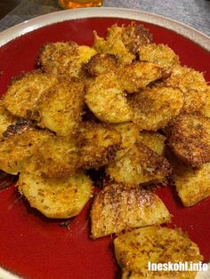 some fried food is on a red plate