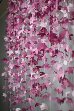 pink paper butterflies hanging from the ceiling