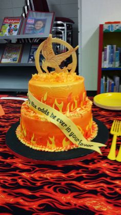 a birthday cake that is on top of a table with forks and utensils