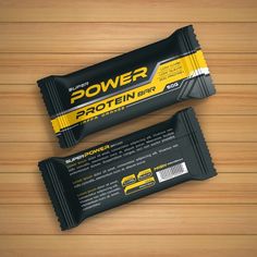 two bar wrappers sitting on top of a wooden table next to each other with the words power protein printed on them