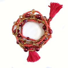 A nice wrap bracelet with tassels in warm autumn or winter colors. The colors are difficult to catch in a photograph, the pink is a color between pink and brown. Bohemian jewelry. Several kinds of beads are used: glass, auroro borealis, pearls and charms. You can wear this bracelet also as a necklace Lenght is 107 cm. Check the lenght. If you wist I can make the bracelet a few cm longer or shorter.  . Each item will be wrapped in attractive wrapping paper and carefully send  in wrapped bubble plastic. It is ready for gift giving. I handcraft every piece with care, but if there is a defect, within 30 days you an return the item to me. I will repair it at no extra costs. If you have special wishes, please let me know.  You can follow me on Instagram and Pinterest: Pinterest: https://nl.pinte Red Beaded Bracelet With 108 Beads For Festival, Bohemian Bracelets With Dangling Beads, Bohemian Red Bracelet With 108 Beads, Bohemian Bracelets With Dangling Beads For Festivals, Bohemian Festival Bracelets With Dangling Beads, Bohemian Multi-strand Beaded Bracelets With 108 Beads, Bohemian Multicolor Beaded Bracelets With Tassels, Pink Bohemian Beads With Dangling Details, Red Bohemian Beaded Bracelet