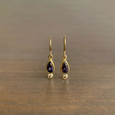 Earthy diamonds underscore the regal tones of these regal purple sapphire teardrops. 

22k & 18k yellow gold 
Sapphires (5mm x 8mm), diamonds 
Earrings measure 3/16" at the widest and hang 1 1/4" from the ear Diamonds Earrings, Teardrop Ring, Brown Diamond, Diamond Drops, Pearl Grey, Raw Crystal