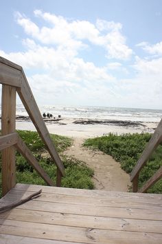 an open wooden door leading to the beach