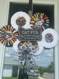 the front door is decorated with wreaths, ribbons and badges for cat pur