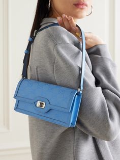 Gucci's 'Luce' shoulder bag has been made in Italy from canvas-jacquard featuring the label's signature 'GG' monogram. Trimmed with leather, it has a slim, elongated silhouette with enough space inside for your phone, cardholder and keys. Detach the striped webbing strap to carry yours as a clutch. Gucci Blue Shoulder Bag With Removable Pouch, Blue Gucci Shoulder Bag For Everyday Use, Blue Gucci Shoulder Bag, Blue Gucci Shoulder Bag For Formal Occasions, Formal Blue Gucci Shoulder Bag, Blue Gucci Shoulder Bag With Branded Hardware, Gucci Blue Shoulder Bag With Detachable Strap, Blue Gucci Shoulder Bag With Detachable Strap, Blue Gucci Crossbody Shoulder Bag