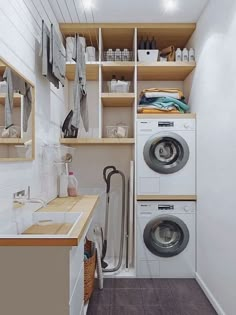 a washer and dryer in a small room with shelves above the washer