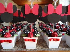 minnie mouse party decorations and centerpieces in white flower pots with red bow ties