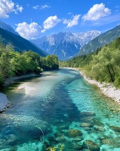 the water is crystal blue and clear with mountains in the background