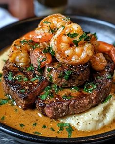 steak with shrimp and mashed potatoes on a plate