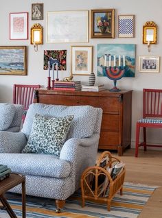 a living room filled with furniture and pictures on the wall