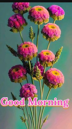 a vase filled with pink flowers sitting on top of a table next to a sign that says good morning