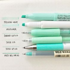 four pens sitting on top of each other in front of a white sheet with information