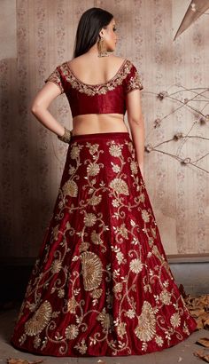 Semi Velvet Wedding Lehenga in Red and Maroon with Zari work Product Details: Fabric:Semi Velvet Work:Embroidered, Thread, Zari Color Family:Red and Maroon Occasion:Wedding Washing Instruction:Dry Wash This is made to order product. We customize the pattern of the dress to suit your style and fitting. Once you place the order we will provide you with a template for measurements (to be taken in inches). It usually takes a week's time for your dress to get dispatched after we receive your measurem Bollywood Lehenga For Marriage During Diwali, Traditional Embroidered Choli For Ceremony, Red Embroidered Floor-length Choli, Embroidered Sets With Traditional Drape For Marriage, Embroidered Sets For Marriage With Traditional Drape, Embroidered Marriage Sets With Traditional Drape, Embroidered Gown For Marriage And Festive Occasions, Festive Embroidered Gown For Marriage, Embroidered Wedding Sets With Traditional Drape