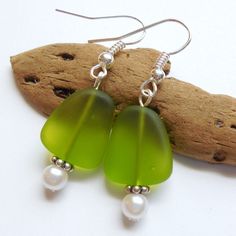 Lime Green Sea Glass Earrings,Sea Glass Jewelry,Seaglass Earrings,Seaglass Jewelry,Beach Glass Jewelry,Beach Glass Earrings,Beach Jewelry. Handmade dangle earrings feature a 15 mm Lime Green recycled sea glass flat bead and a 4mm pearl.  These earrings are a pretty translucent green color and are available in earwire, earpost or clip on.  Specify your choice of style: Earwire, Earpost or Clip on.  Upgrade all non-decorative silver to Sterling Silver for an additional charge of $6: https://www.et Beach Earrings With Recycled Glass And Ear Wire, Beach Earrings With Sea Glass And Ear Wire, Beach Sea Glass Earrings With Ear Wire, Green Recycled Glass Earrings For Beach, Glass Dangle Earrings For The Beach, Sea Glass Teardrop Earrings For Beach, Nickel-free Green Earrings For Beach, Beads Inspiration, Beach Glass Jewelry