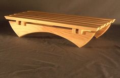 a wooden bench sitting on top of a bed