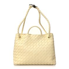 This is an authentic BOTTEGA VENETA Nappa Intrecciato Medium Andiamo Shoulder Bag in Chamomile. This stylish bag is crafted of light yellow nappa leather with Bottega Veneta's signature woven detailing. The bag features a rolled leather top handle, and a longer woven leather strap that can be worn as a crossbody or shoulder bag with an aged gold knot shaped clasp to remove the strap. The top opens to a leather interior with a pouch connected to the removable strap with a zipper compartment and p Classic Woven Leather Shopping Bags, Classic Woven Leather Bags For Shopping, Classic Woven Leather Bag With Double Handle, Classic Woven Leather Tote Bag, Designer Woven Leather Satchel Bag, Designer Woven Leather Satchel, Luxury Shoulder Bag With Braided Handles For Shopping, Designer Shoulder Bag With Braided Handles, Luxury Shoulder Bag With Braided Handles For Daily Use