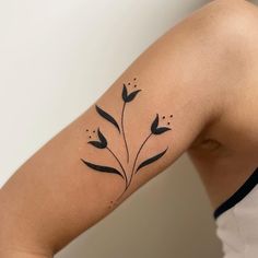 a woman's arm with black flowers on it