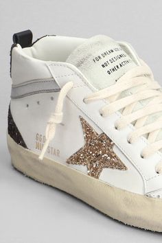 Mid Star Sneakers in white leather, laces, logo on tab, round toe, star on side, glitter details, laminated leather details, logo on heel, worn effect, 100% leather, Made in ItalyGender: WomenMaterial: LEATHERColor: WHITEMade in: ITProduct ID: 401917_GWF00122F006136*Import tax/duty will be calculated at checkout (If applicable) Golden Goose Mid Star, Golden Goose Mid, Golden Goose Shoes, Star Sneakers, Top Designer Brands, Leather Logo, Golden Goose, High End Fashion, Exclusive Collection