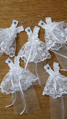 four pieces of white lace with bows on them