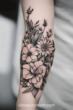 a black and white flower tattoo on the arm