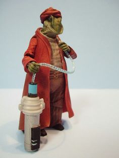 a statue of a man in red holding a pipe and wearing a red coat with the words cutout on it