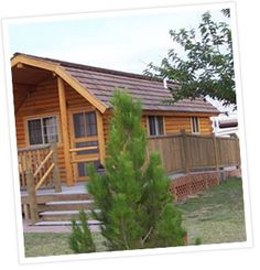 a small wooden cabin with stairs leading up to it