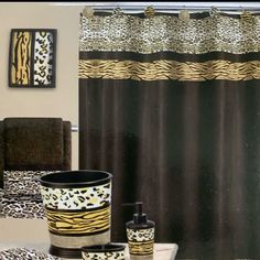 a bathroom with leopard print shower curtain and toiletries