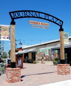 the entrance to a farmers market on a sunny day