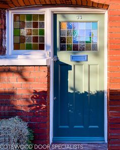 a blue front door with stained glass panels