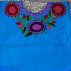 Mexican Top Embroidered Blusa Mexicana Blue Blue Floral Embroidery Top For Vacation, Blue Floral Embroidery Beach Tops, Blue Cotton Top With Floral Embroidery, Light Blue Floral Embroidery Tops For Vacation, Blue Embroidered Short Sleeve Top For Vacation, Vacation Blue Embroidered Cotton Top, Traditional Blue Tops With Floral Embroidery, Bohemian Blue Tops With Embroidered Neckline, Blue Bohemian Tops With Embroidered Neckline