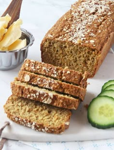 sliced loaf of bread with cucumber and butter on plate next to bowl of ice cream